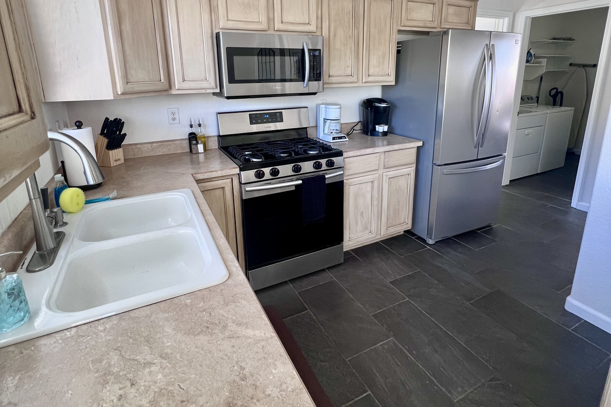 Cooking is a breeze in this fully equipped kitchen, featuring modern appliances and ample counter space.