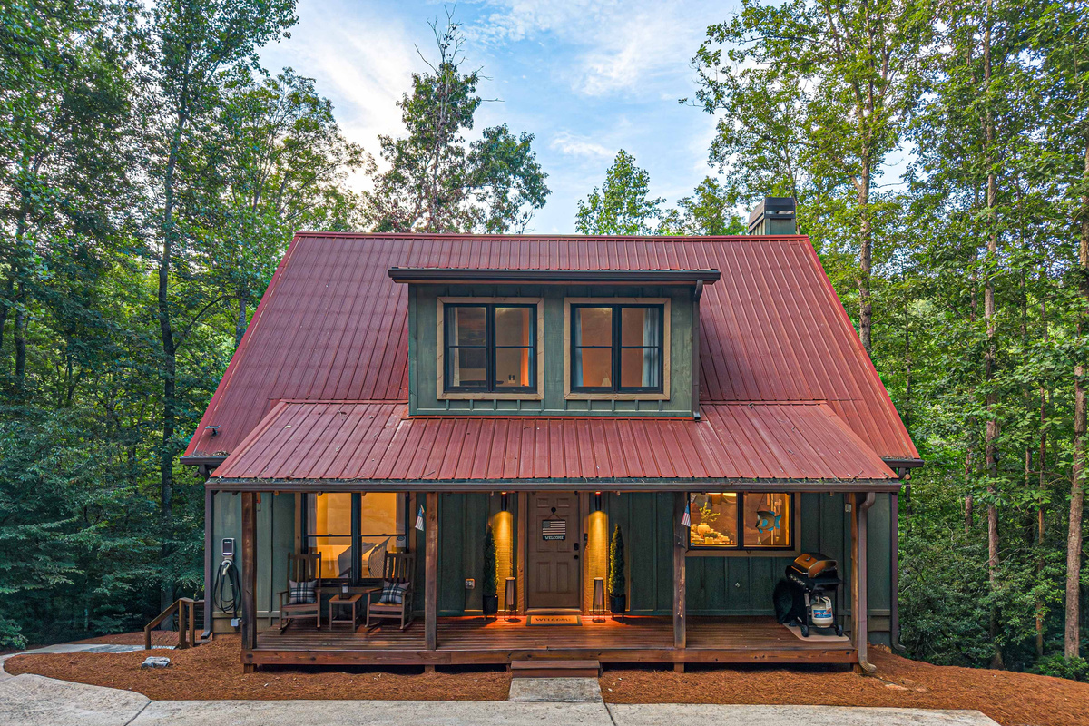 Front of the cabin - propane grill, rocking chairs, & EV Charger.
