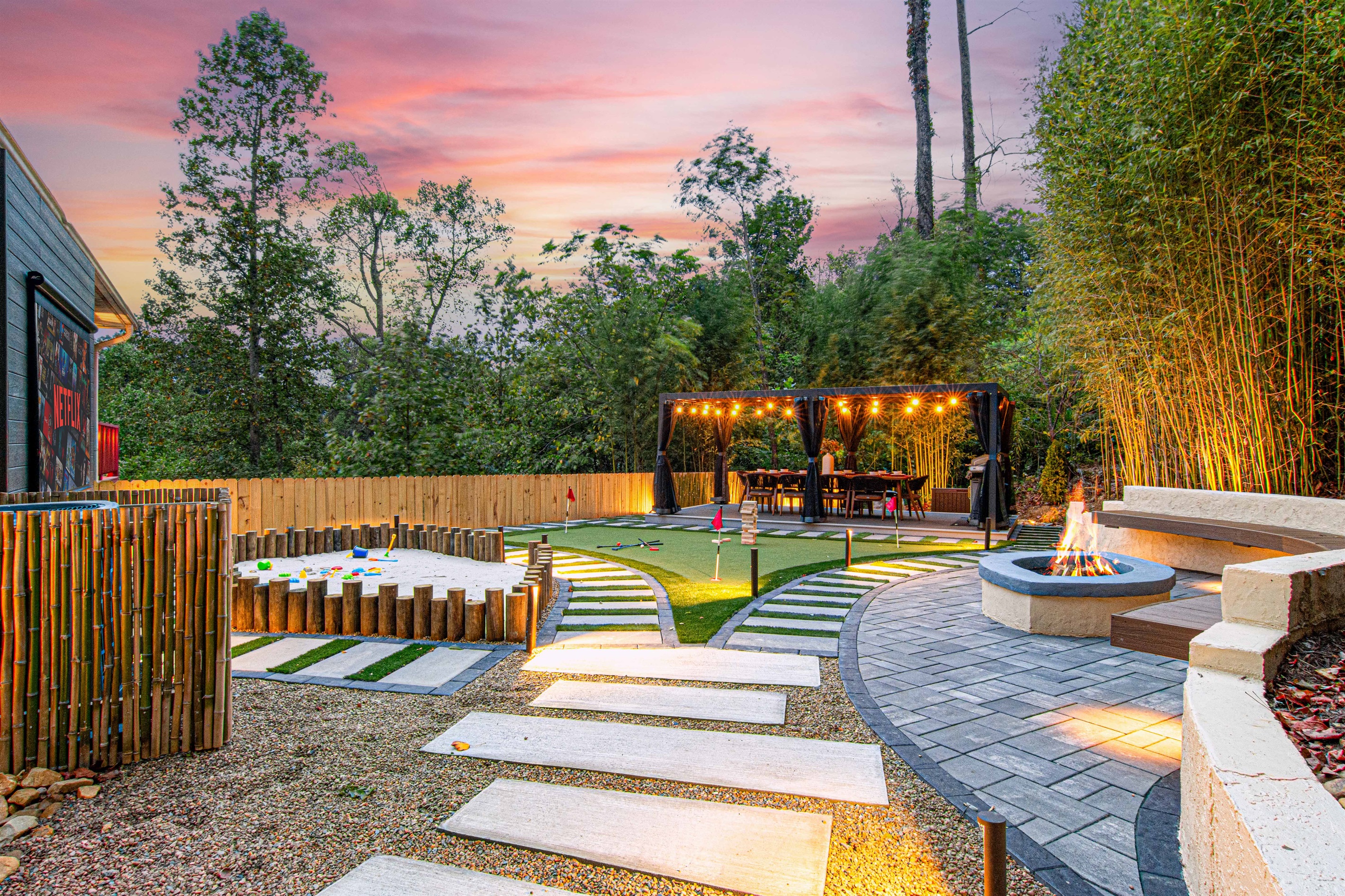 Stroll down the lit pathway to your renovated backyard oasis! Enjoy the sandpit for the kids, dine under the pergola seating 10, gather around the firepit, and challenge friends on the mini-putt. Plus, unwind with movies on the outdoor projector. Your perf