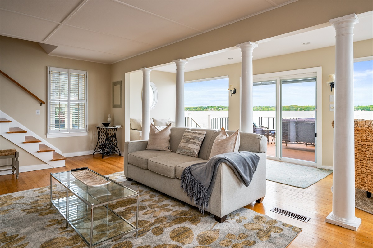 Bright and airy living space with panoramic lake views and direct access to the waterfront deck 🌊🛋️☀️