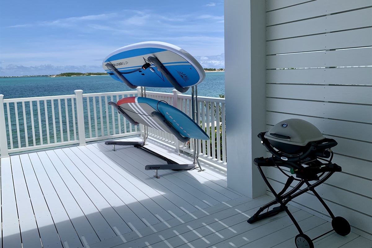 MERMAID COVE  Two paddle boards and a gas grill on the lower deck patio.