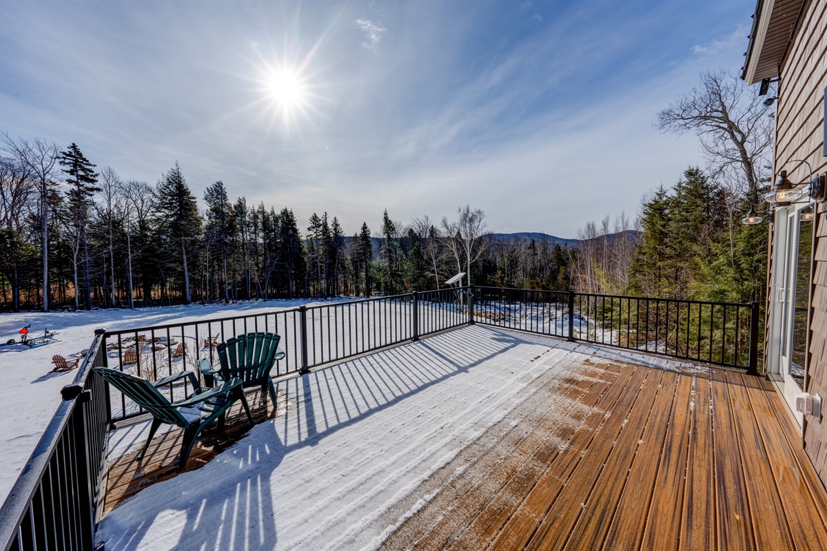 The deck with views.  Accessible from the kitchen sliding glass door or a set of stairs leading to the backyard.
