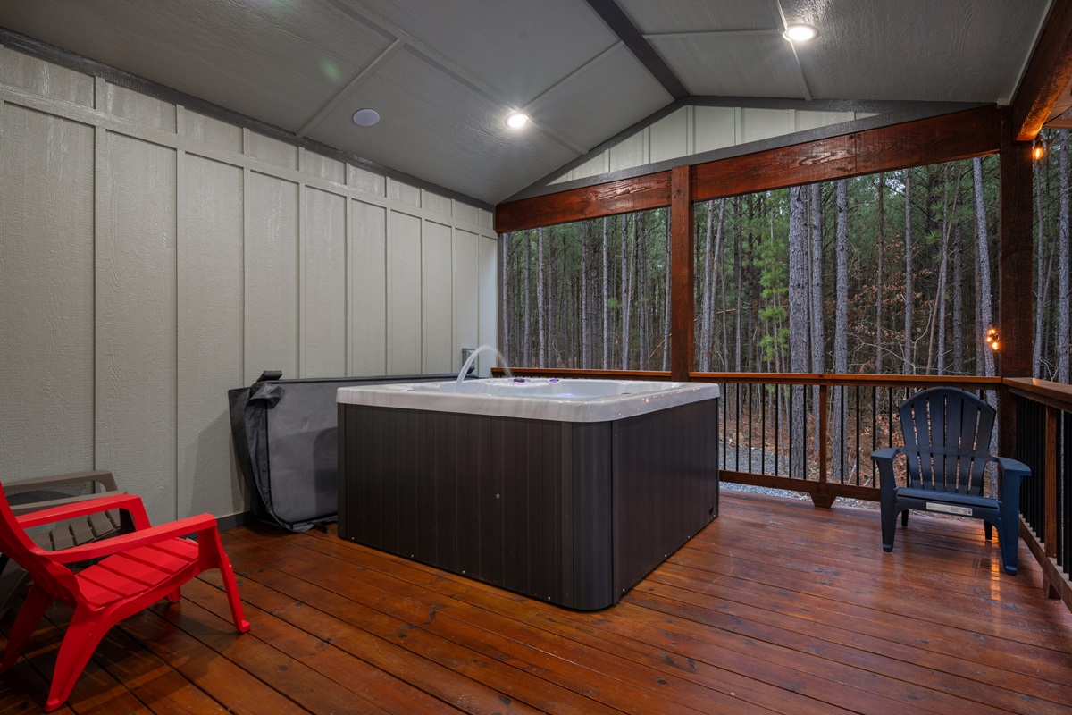 The hot tub sits tucked along the deck, inviting guests to sink into the warm water and unwind after a day of hiking, boating, or exploring.