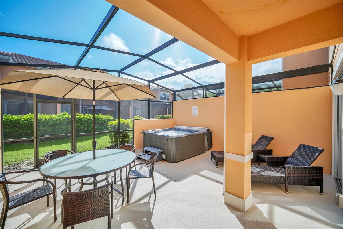 Private lanai with hot tub, lounge chairs and spacious outdoor dining area.