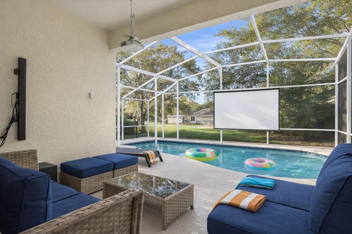 Relax by the screened pool with comfortable seating and poolside cinema!