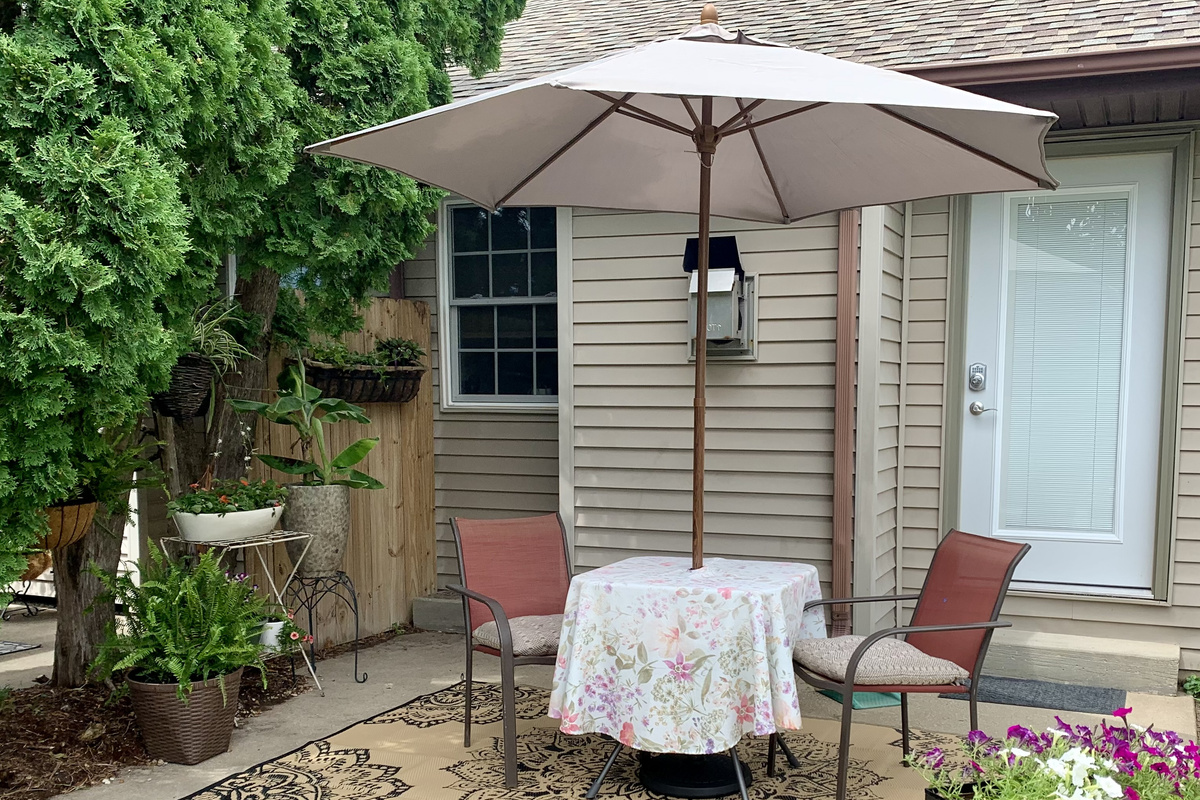Relax with a morning coffee or unwind with an evening glass of wine on the quiet patio. Summer flowers are blooming in abundance across the lawn.
