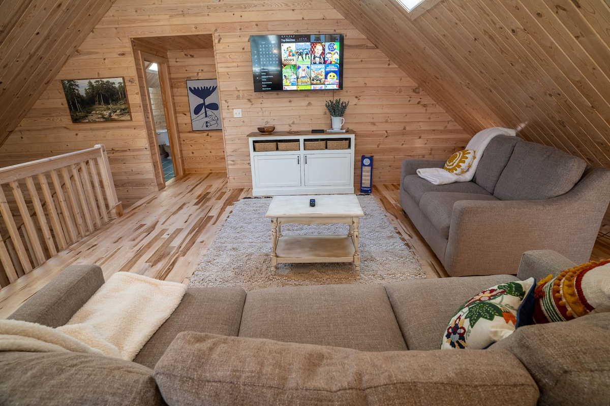 The main living area features comfy couches, a smart TV and lots of games and toys for kids and adults alike.  