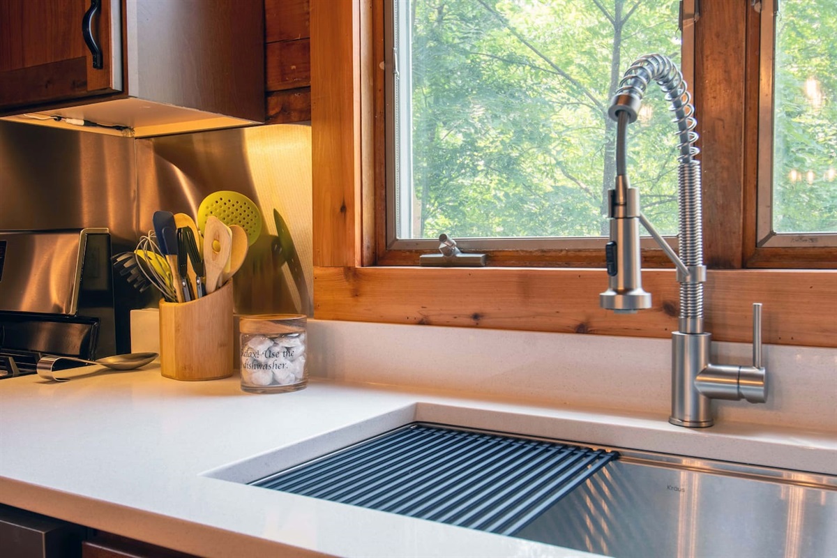 Plenty of dishwasher pods for your use and a drying rack in sink.