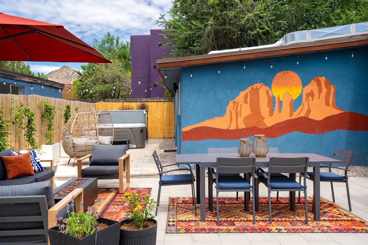 Gather around the fire pit or unwind in the cozy egg chair while enjoying the Cathedral Rock mural and private hot tub in your outdoor sanctuary.