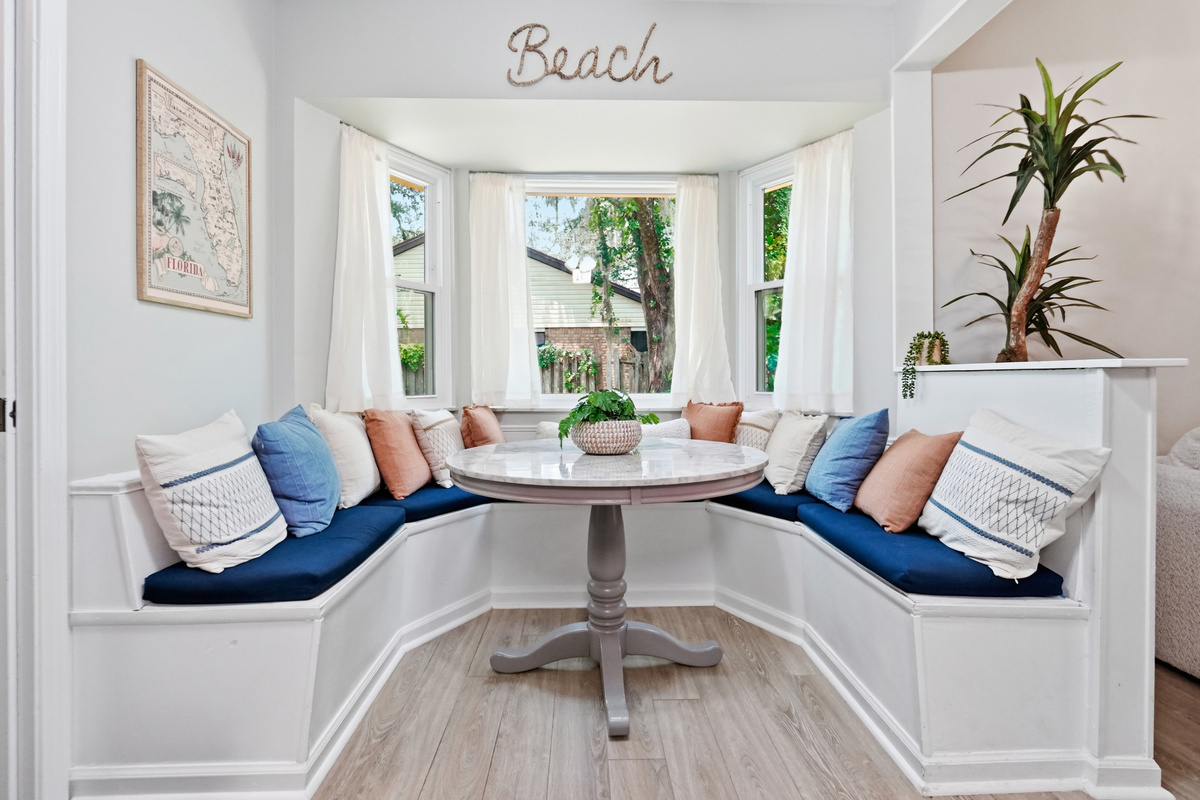 Gather around the charming breakfast nook with wraparound bench seating and plenty of natural light.