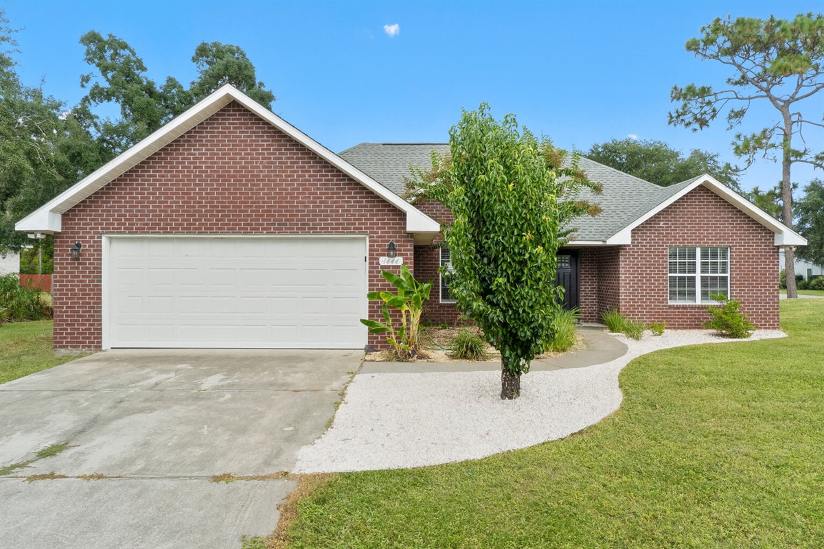 This all-brick beauty combines timeless curb appeal with a clean, well-manicured exterior. The wide driveway, mature trees, and welcoming front entry make it a perfect home base for your getaway—relaxed, private, and easy to settle into.
