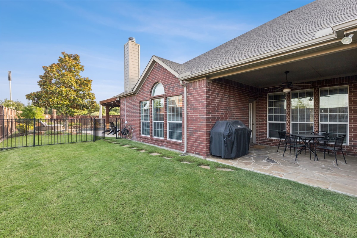 Covered patio with grill and grassy play space for your kids or furbabies.