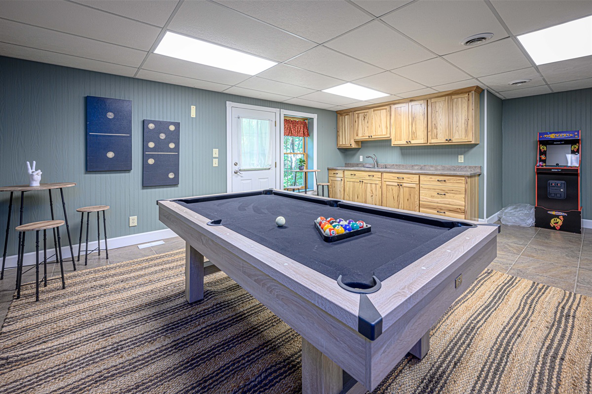 Basement game room includes Pac Man arcade game and 7' pool table