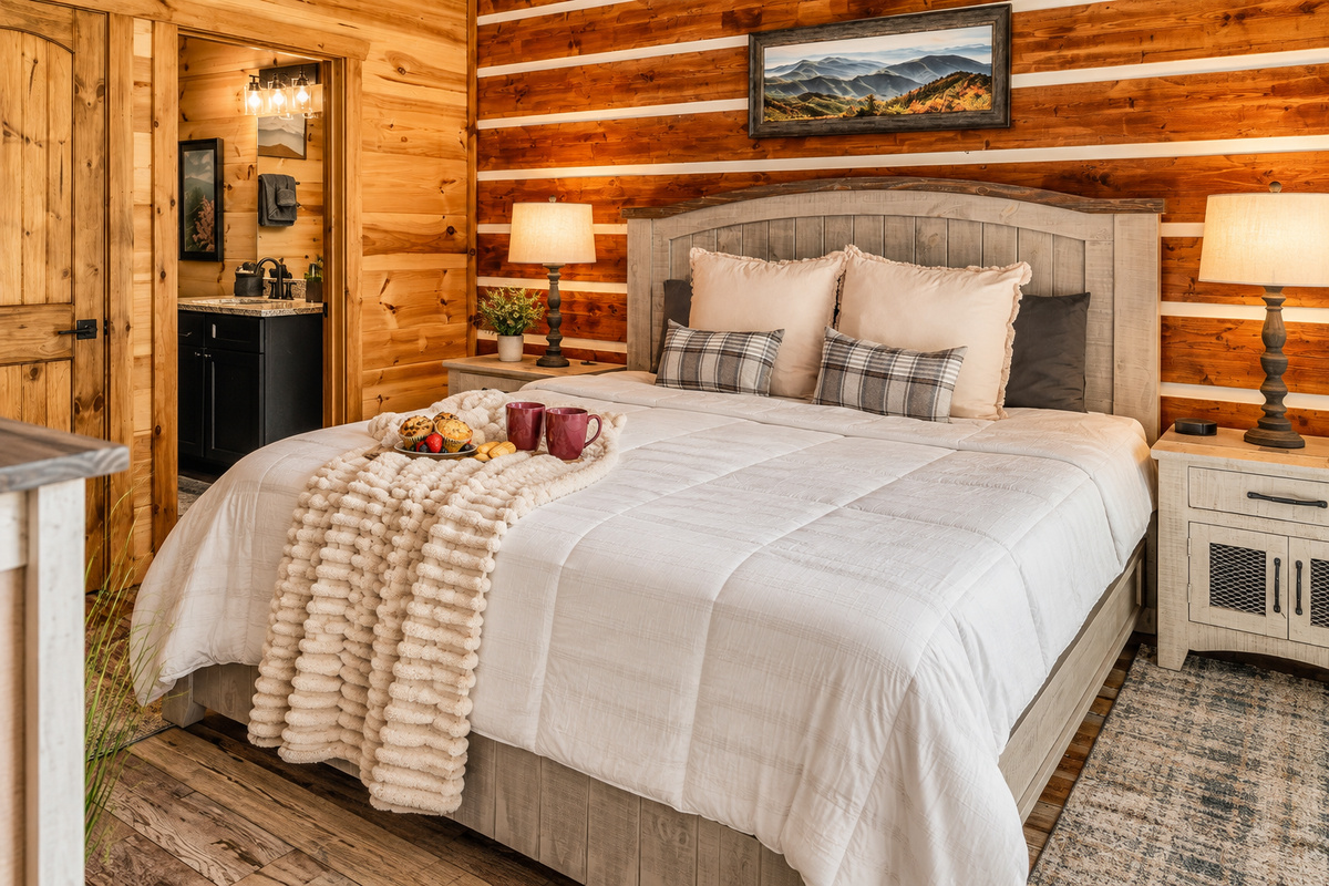 Arched king bed, chunky knit throw, bedside lamps, and a private full bath.