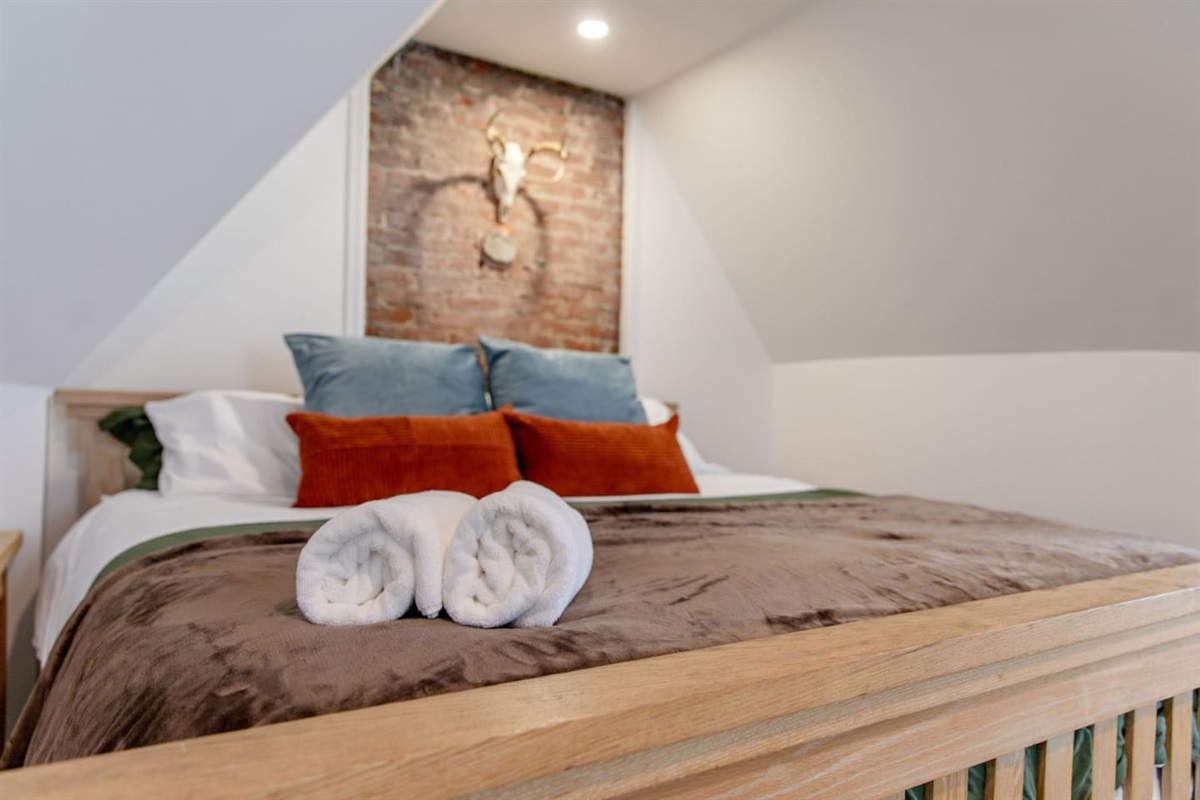 Bed, Pillows, and Towels.