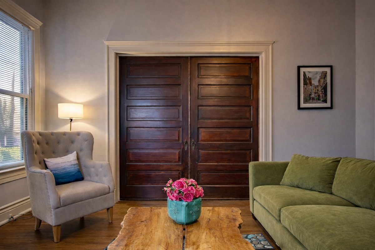 Living Room with Velvet Large Section Sofa and addition side chairs. 55" LED Smart TV.