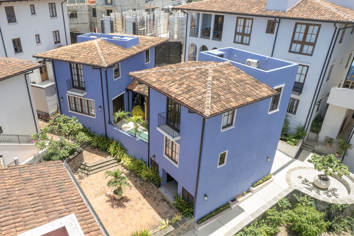 The home is designed with two wings with a central lanai and plunge pool. Living room, kitchen and two secondary bedrooms are located in the right wing.  Primary bedroom and secondary king suite are located in the left wing of the home.