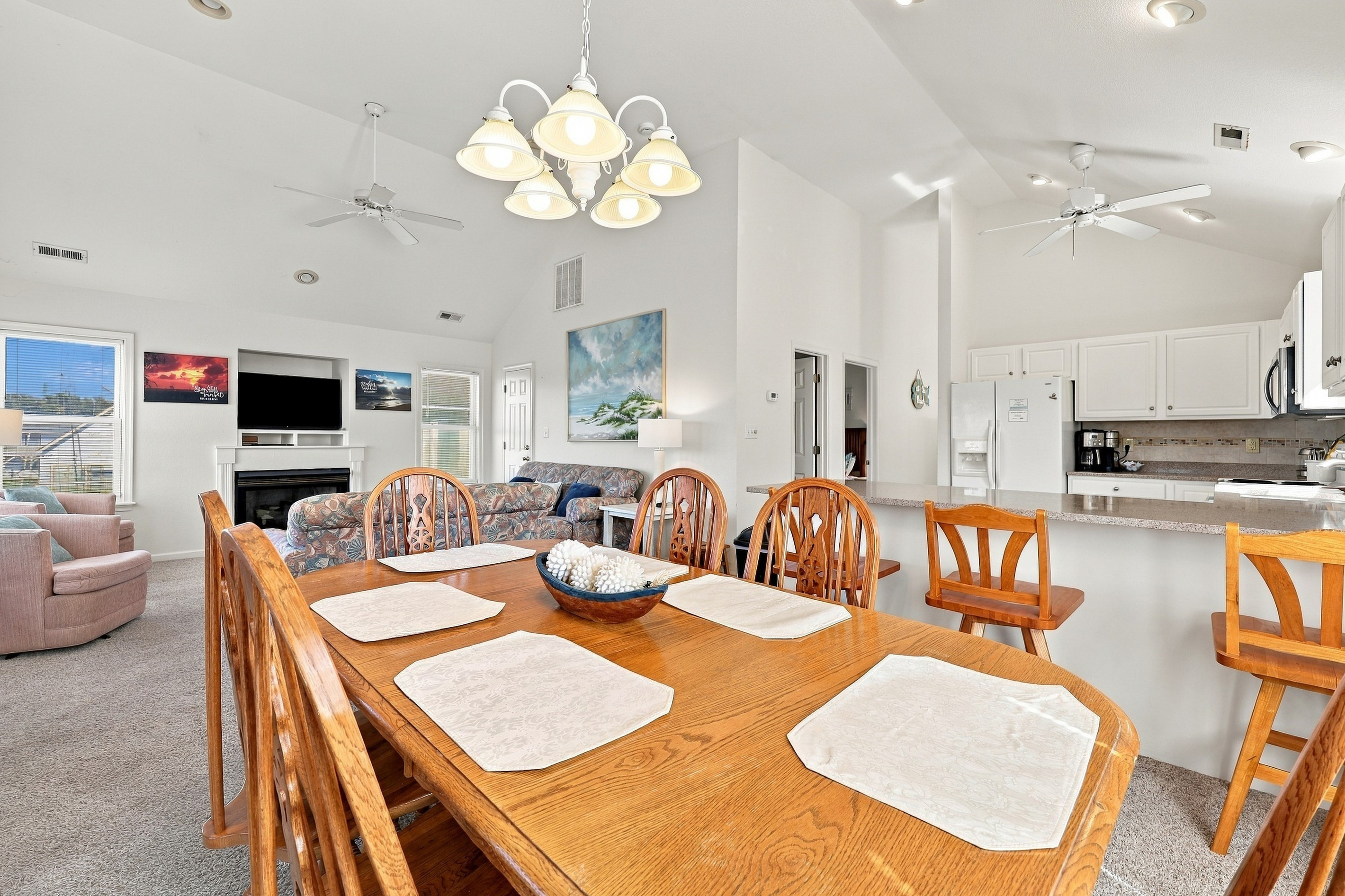 Gather round the dining table for seafood feasts and game nights, with the screened porch just outside.