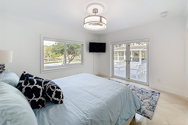 The second bedroom has a great view of the water and pool  with lots of light. Like the rest of the house, the remote blinds are great. 
