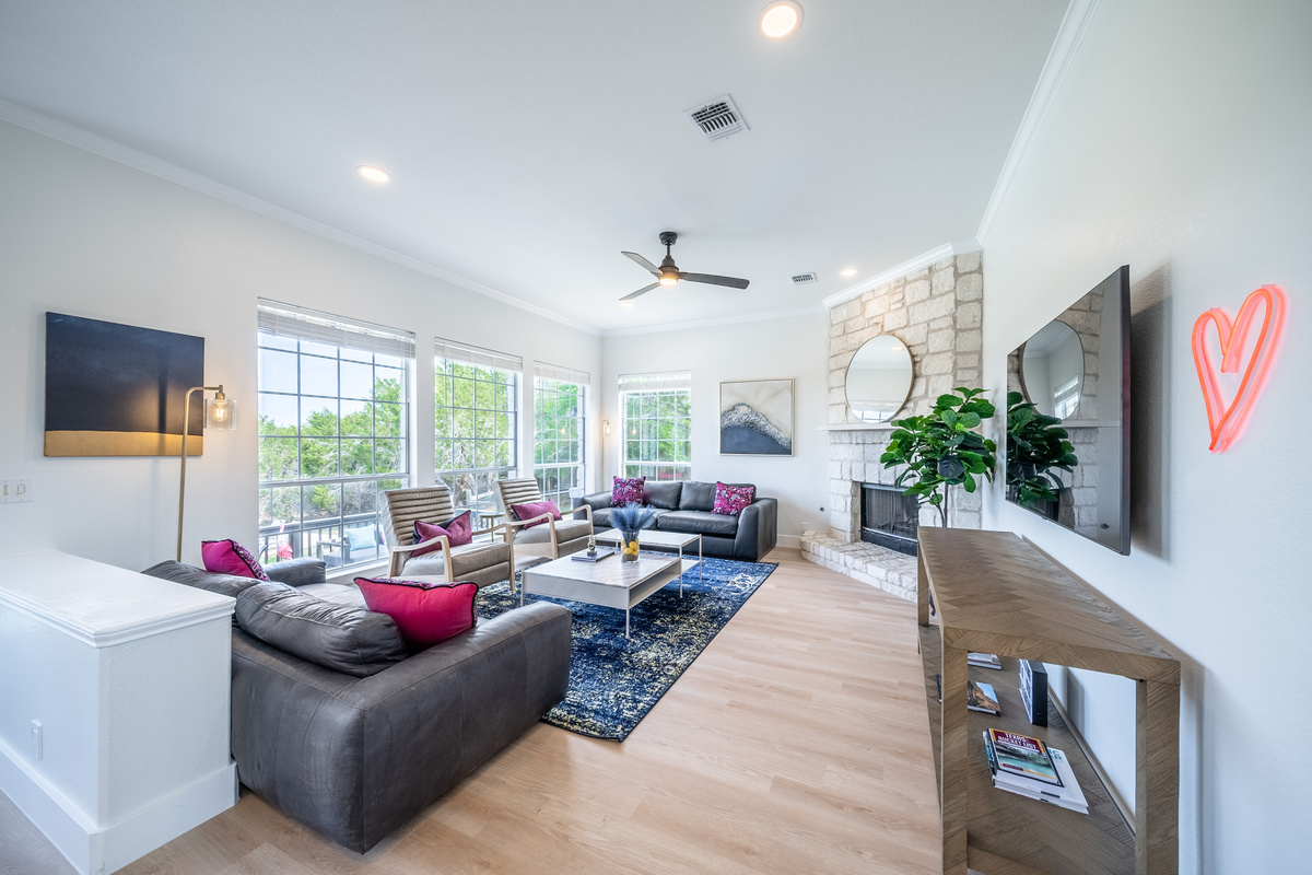 Open-concept living room with plush seating and a cozy fireplace.