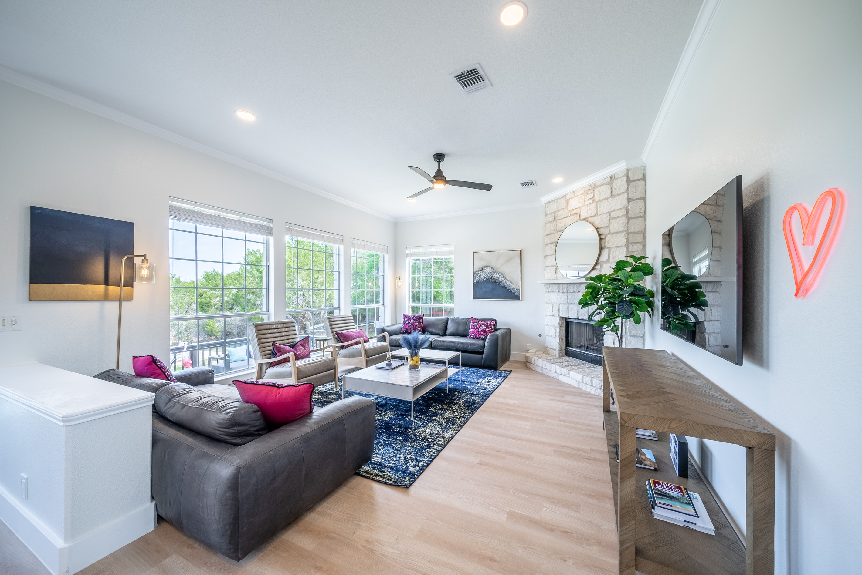 Open-concept living room with plush seating and a cozy fireplace.