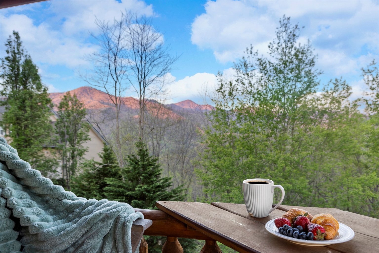 Balcony Delight: Sip coffee with breathtaking mountain views and fresh pastries at sunrise!