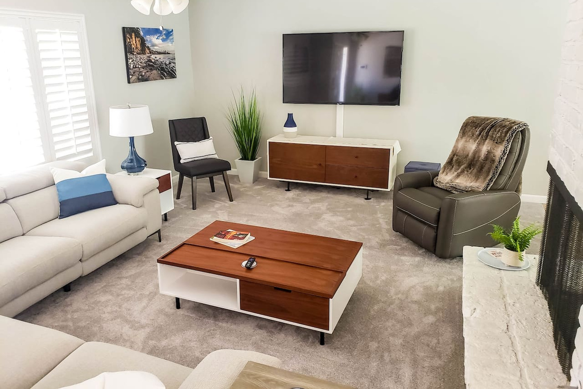 Large comfortable living room. Recliner chair and couch. Large 65 inch Smart TV.