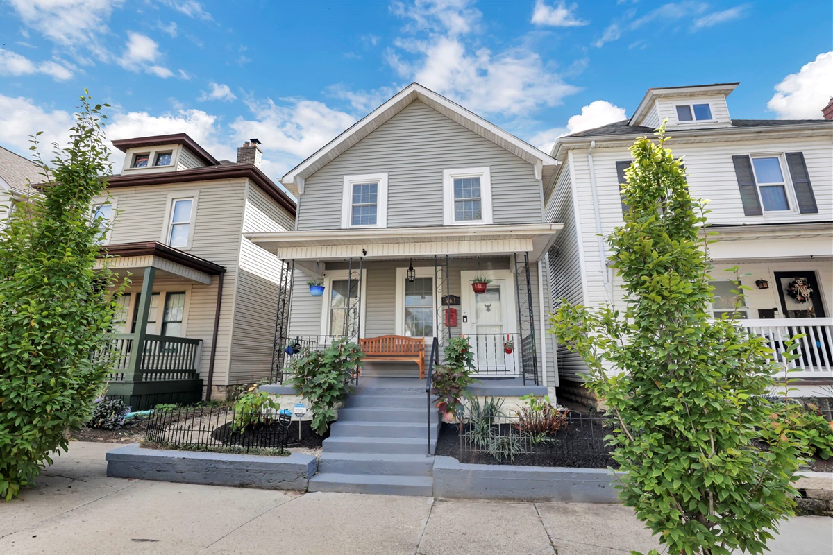 Enjoy a charming front porch on a quaint brick street