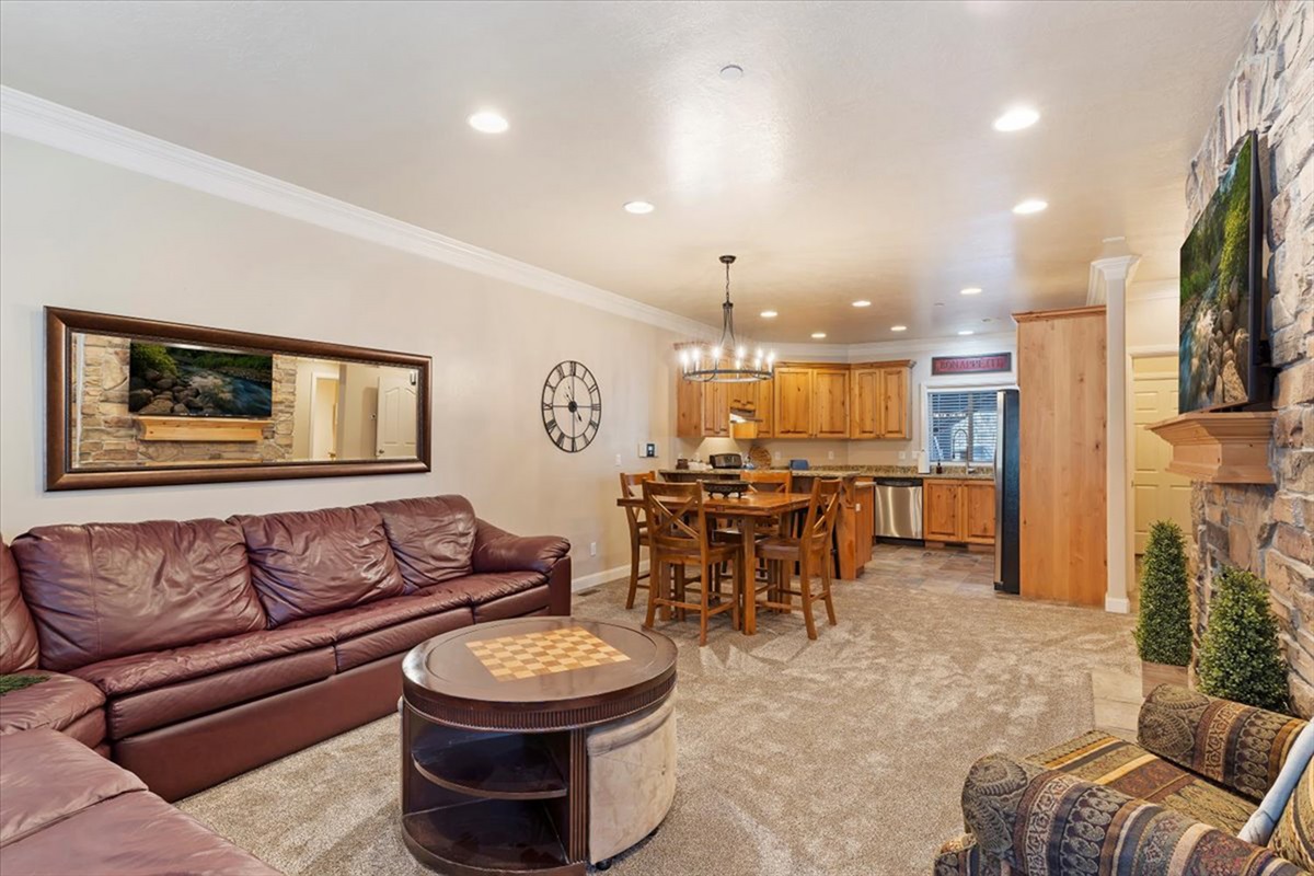 A spacious and welcoming living room designed for comfort, with ample seating and a seamless connection to the dining area.