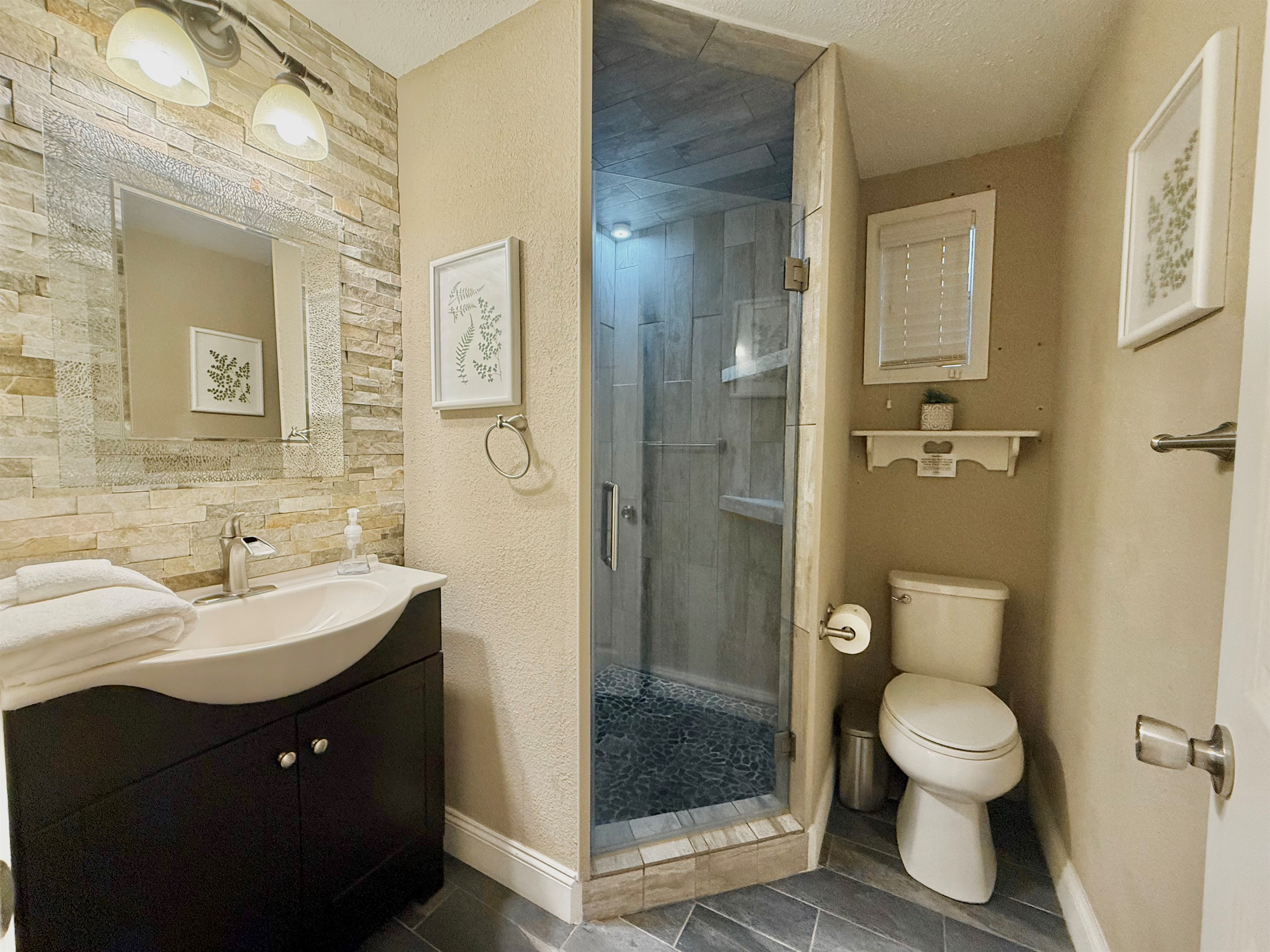 From the elegant wall textures to the stylish vanity and open shelving, every detail has been designed with your comfort in mind.