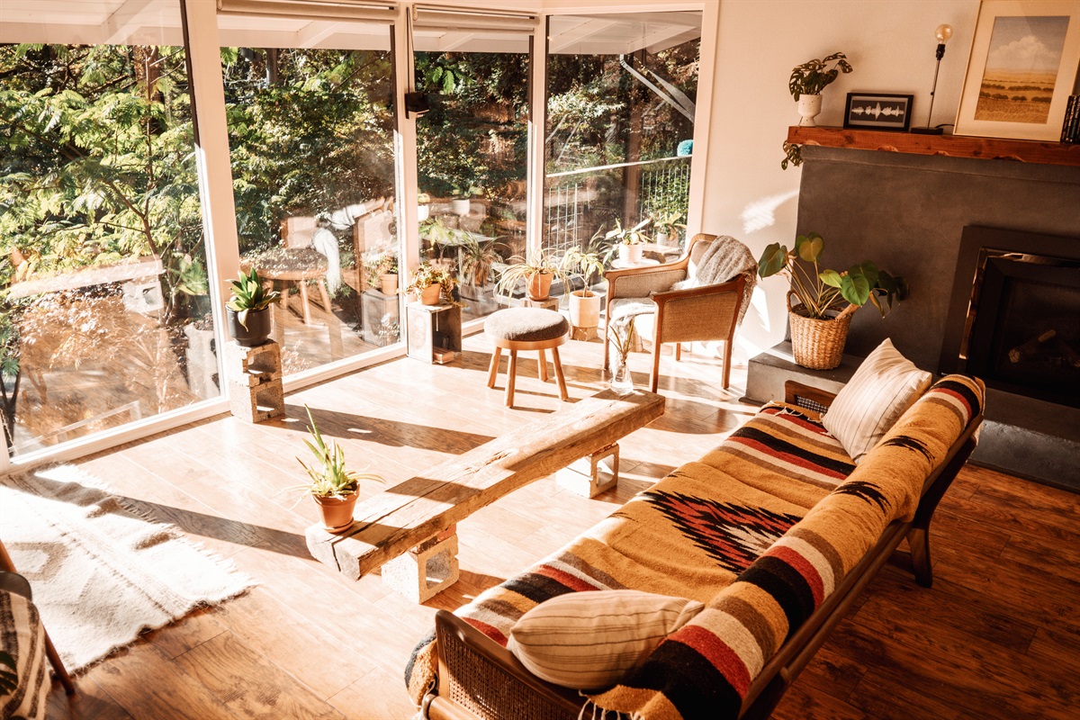 Golden sunlight and forest views,  the living room at its calmest.