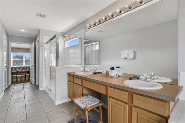 Master bathroom with double vanities, shower booth and soaking bath tub