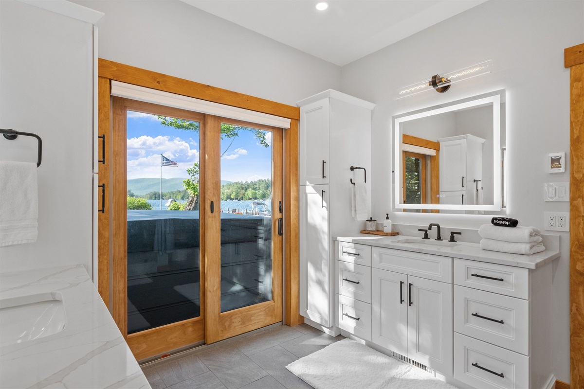 First floor master bathroom with dual vanities, heated floors, and walk in shower