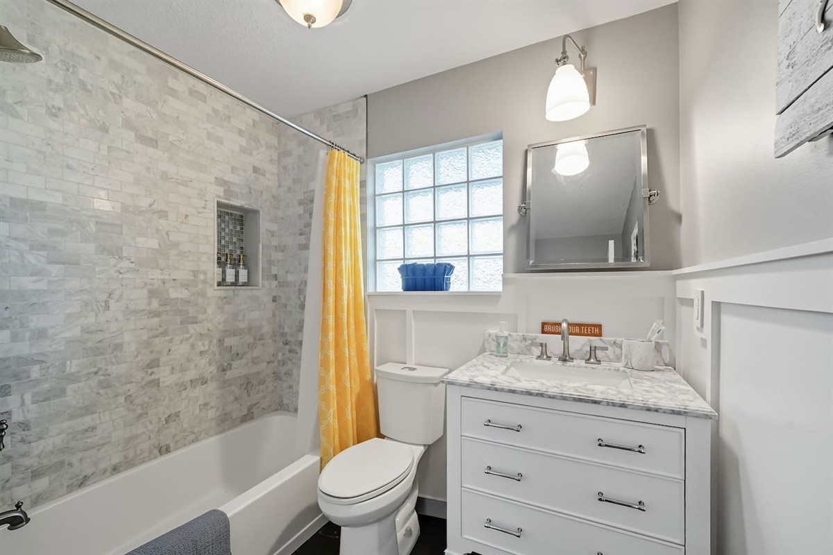 Upstairs guest bathroom with shower and tub