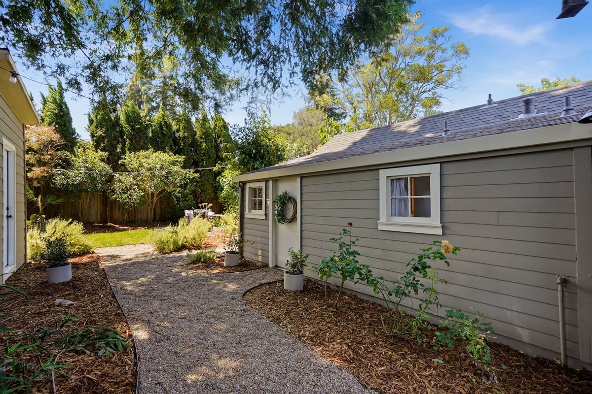 Charming private studio entrance with stylish outdoor seating, peaceful surroundings, and a welcoming Napa retreat feel.
