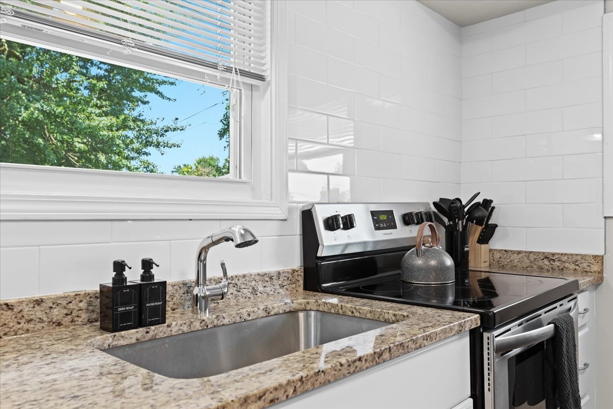 Bright, updated kitchen stocked with cooking tools
