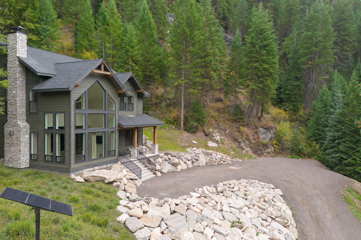 View of the switchback driveway and car & trailer parking located at the center right of the photo.