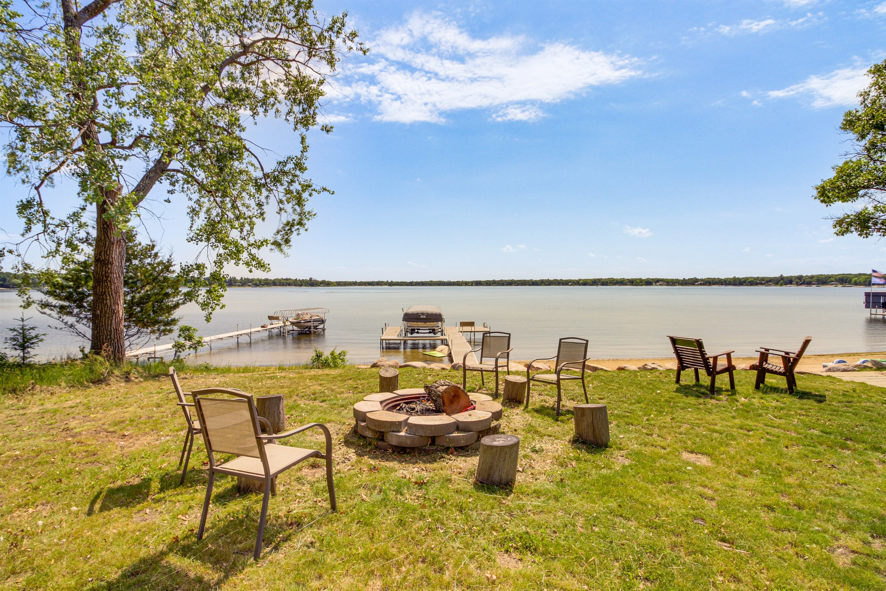 Lakeside fire pit with seating and sandy shoreline on White Sand Lake
