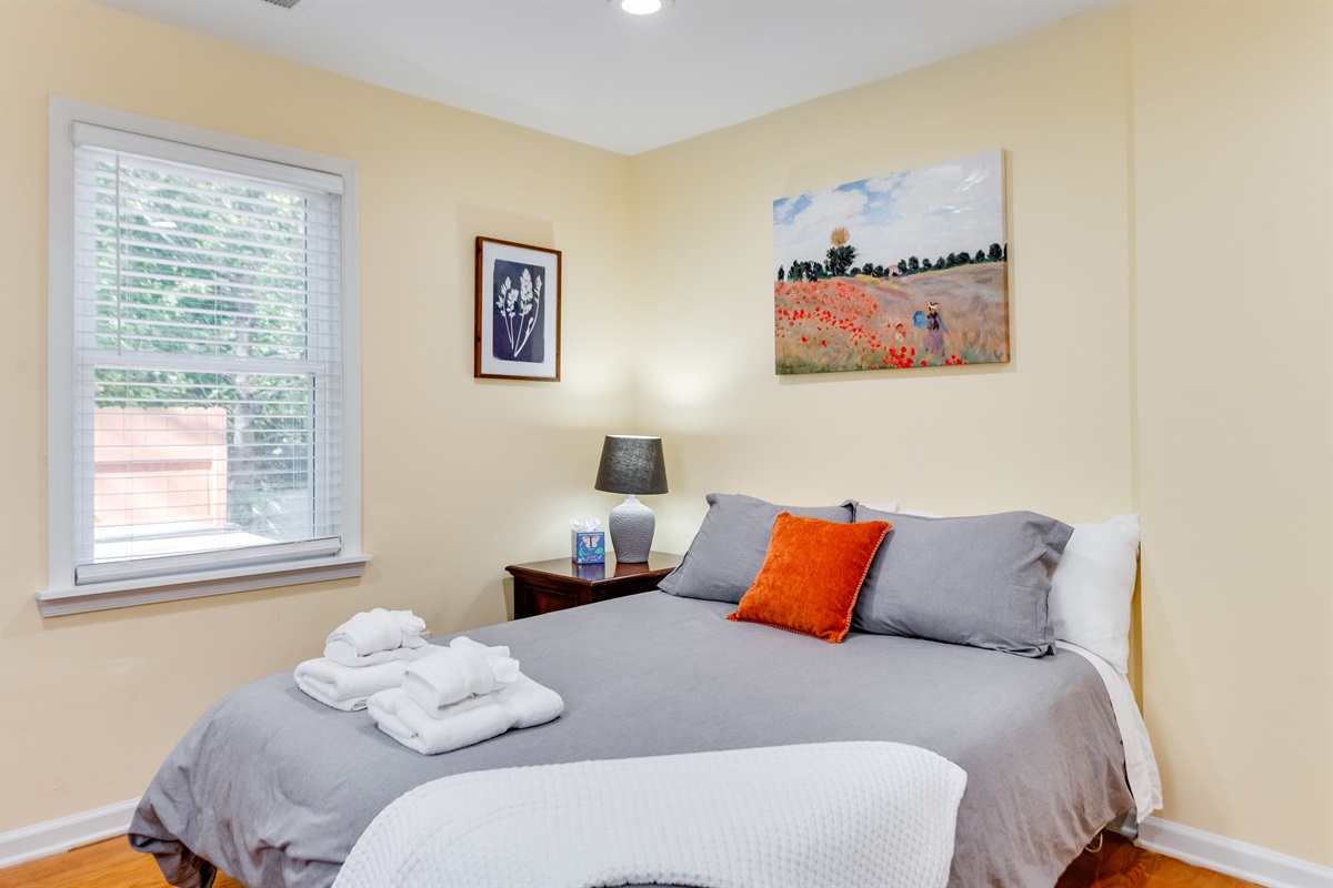 Upstairs Queen Bedroom 2: Wake up refreshed in this bright room with artistic decor and cozy linens! 