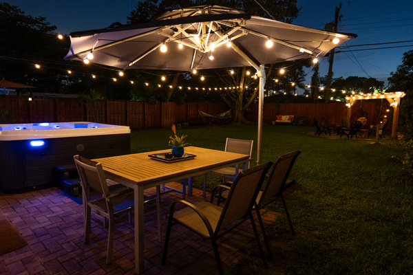 Outdoor dining table area besides hot tub