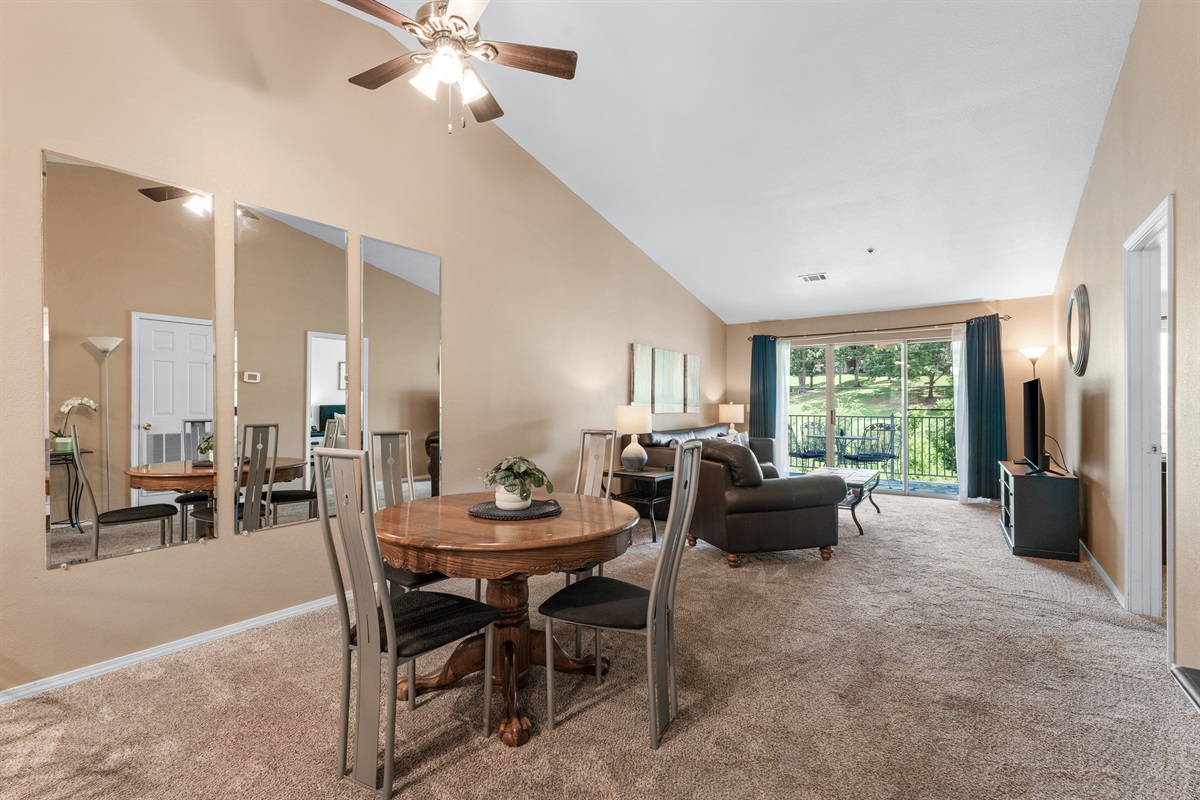 Open sightlines and vaulted ceilings help the condo feel airy, social, and larger than a typical two-bedroom.