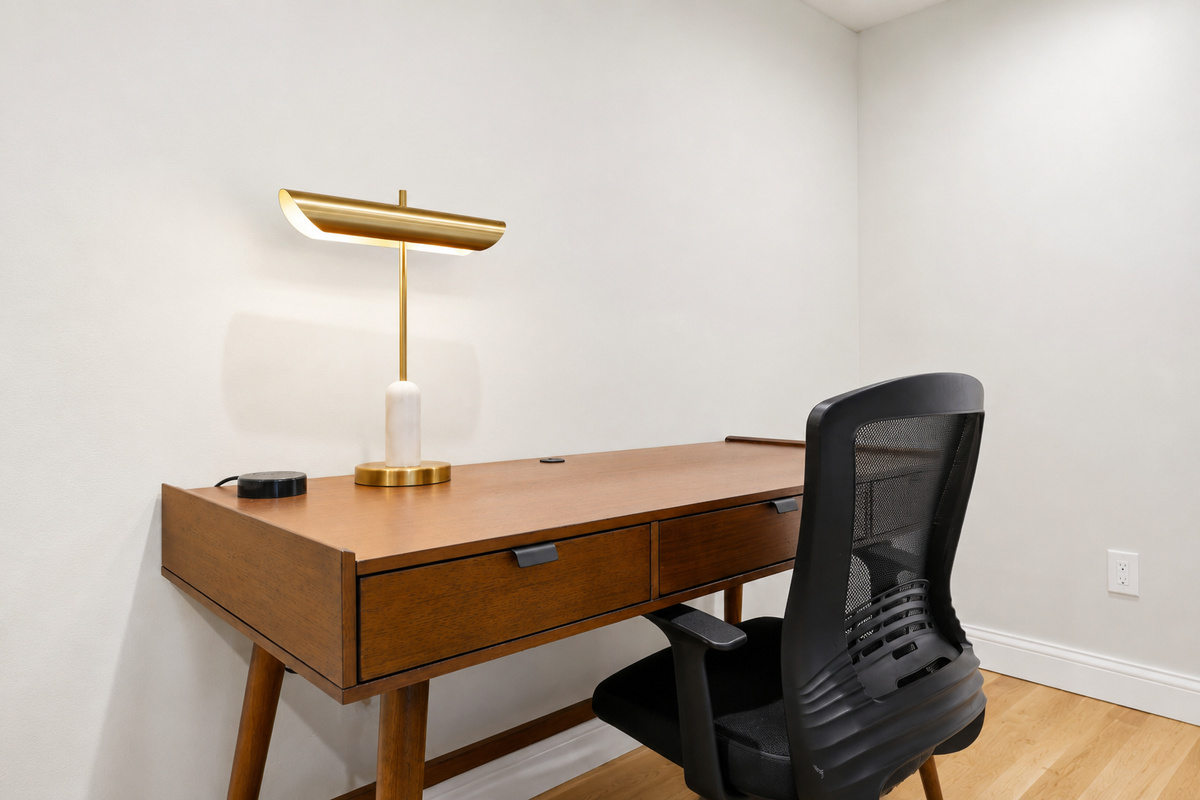 Comfortable workspace featuring a wood desk, ergonomic chair, and wall-mounted TV. A clean, quiet setup ideal for remote work, studying, or catching up on emails during your stay.