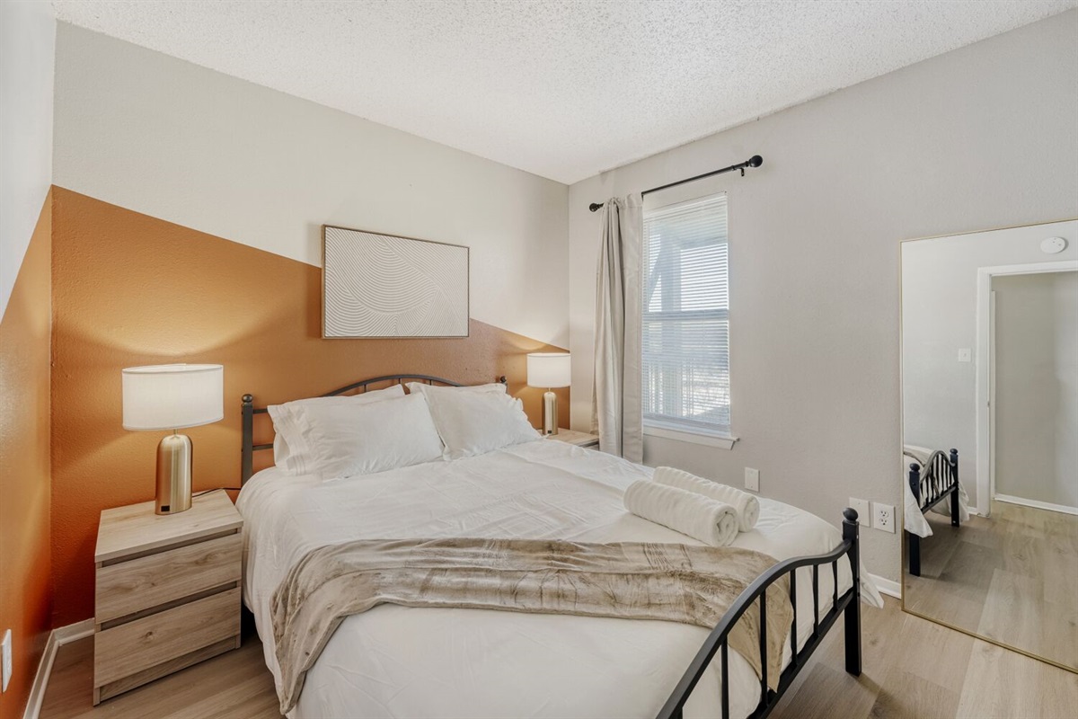 Cozy bedroom with warm tones and modern minimalist style.