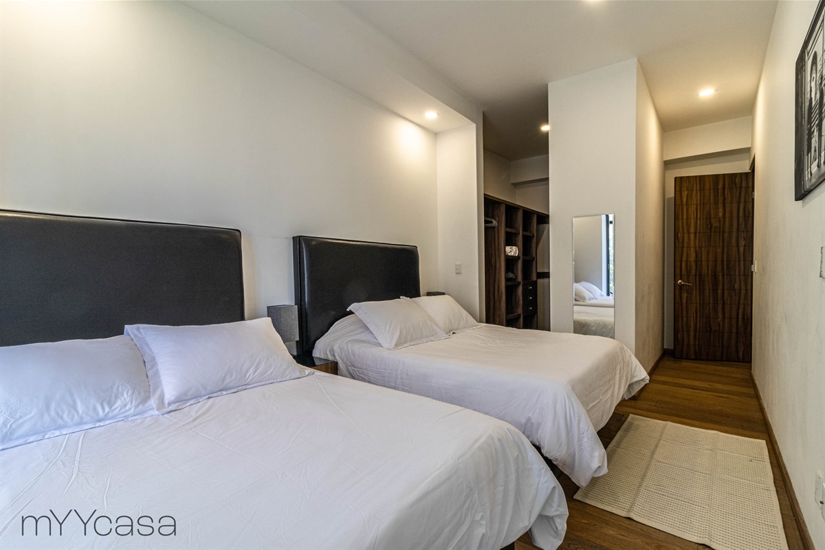Third bedroom featuring a spacious walk in closet, offering ample storage for clothing and personal items