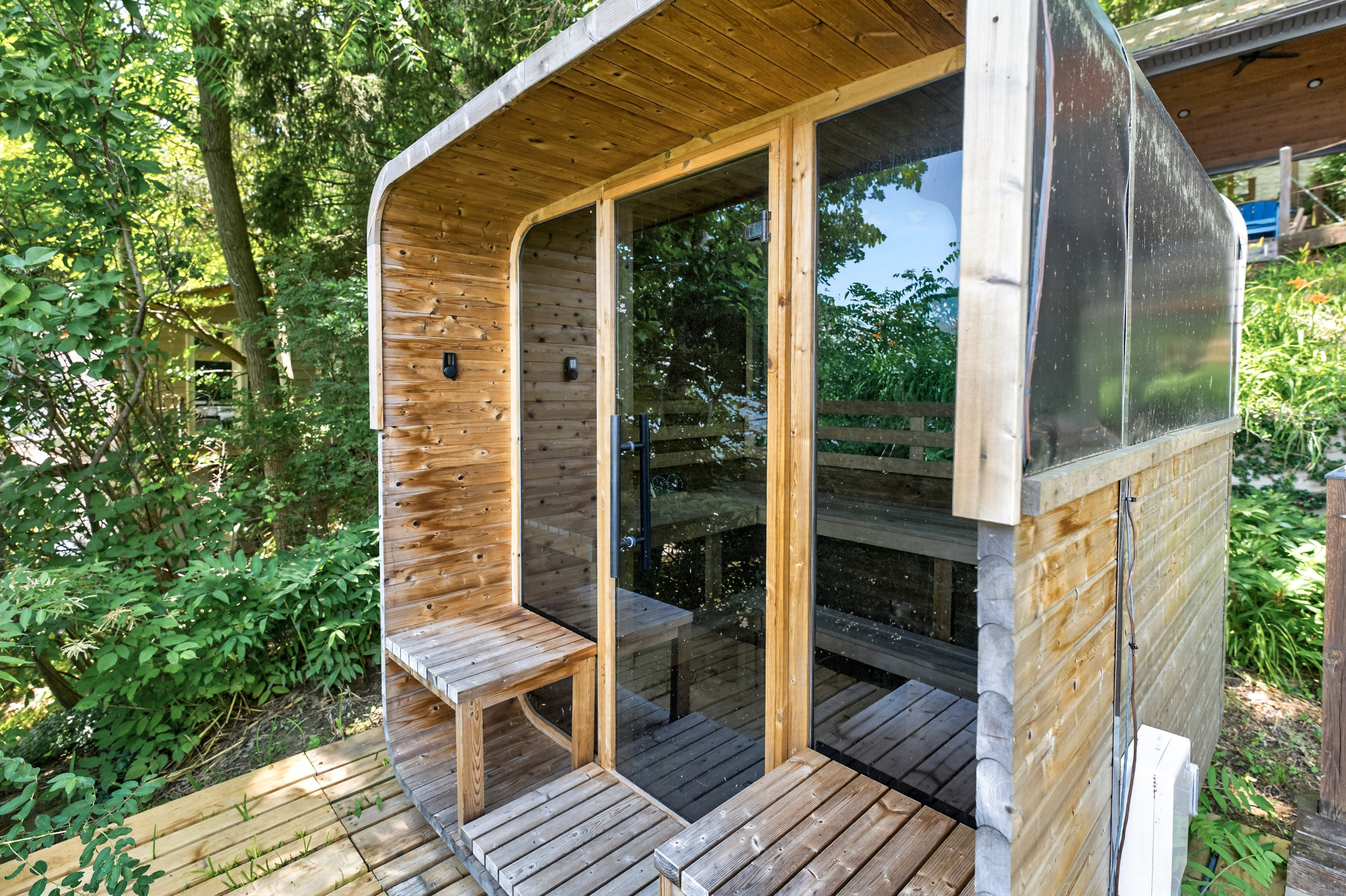 Outdoor sauna with glass entrance