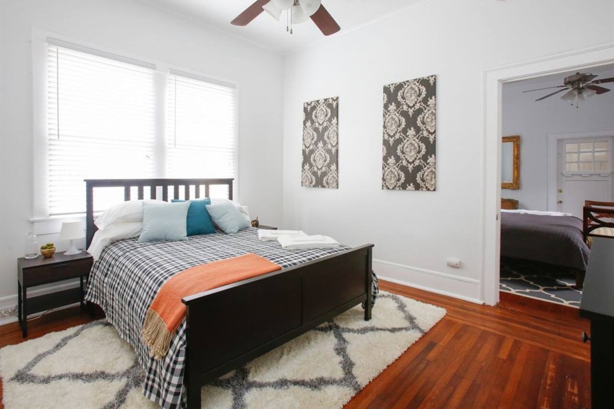 Queen bedroom.  Walk through to the king bedroom, but each have private access to the shared full bathroom.  Feature small cable tv and a dresser.