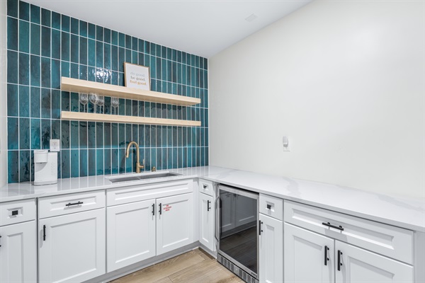 Kitchenette in carriage house with mini fridge, sink, and coffee maker. 