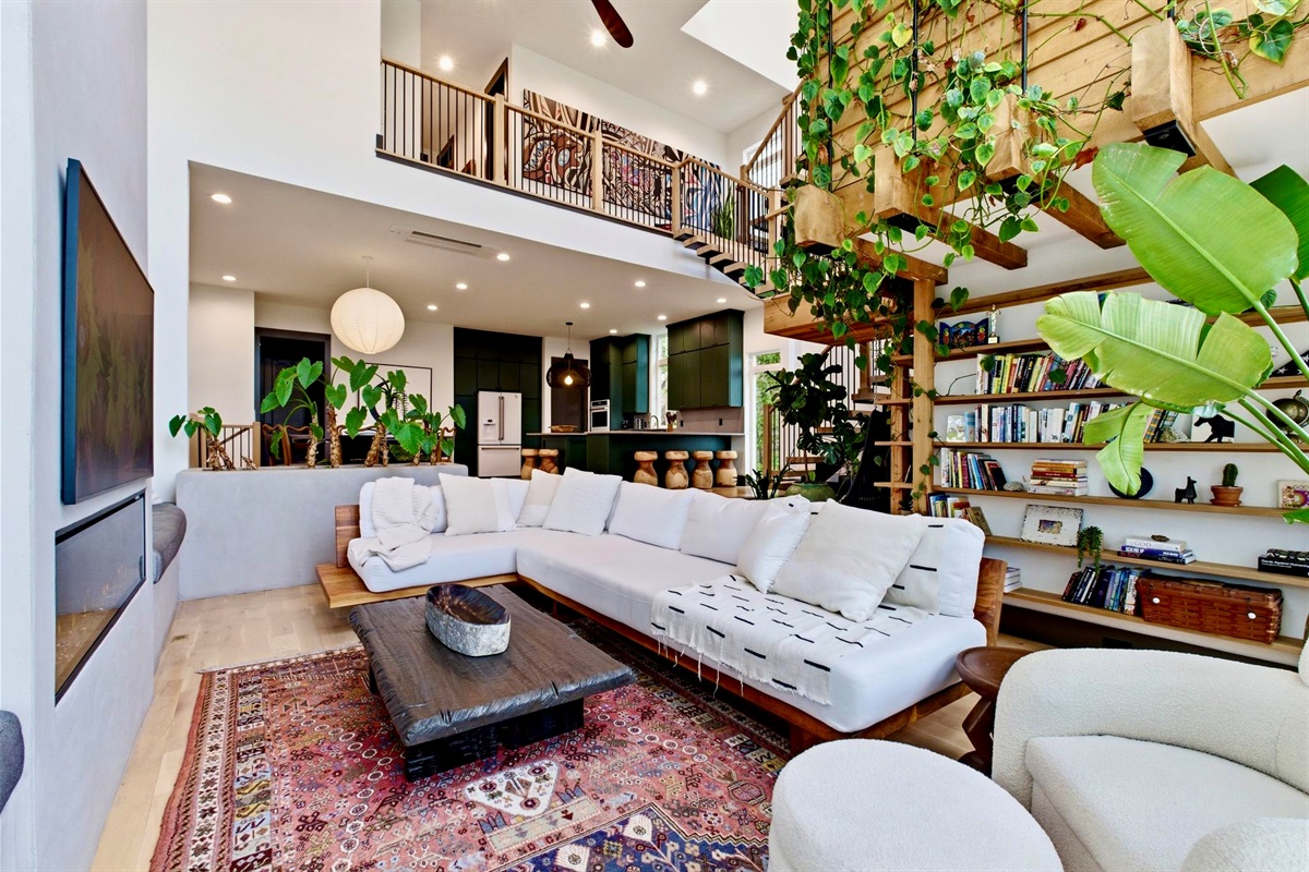 Eclectic living room w/ built-in bookshelves, patterned rug & a laid-back, creative energy.

