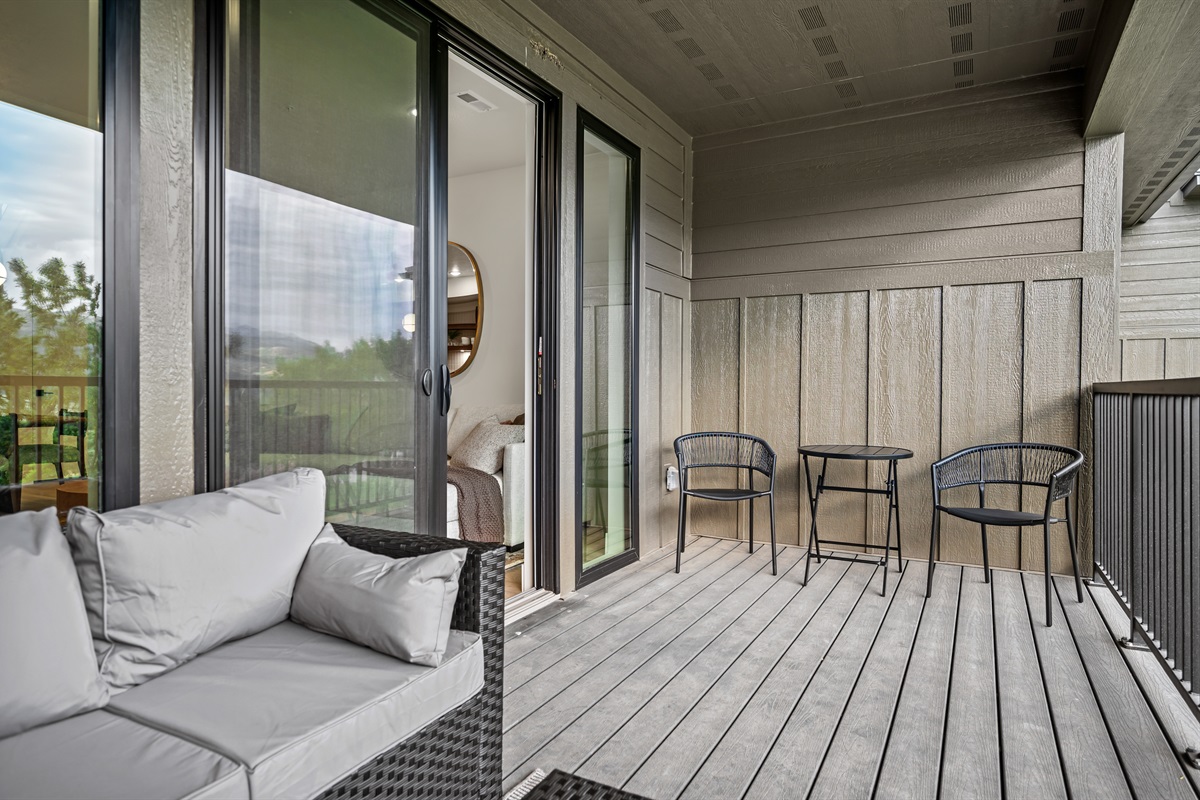 Sliding doors open to a furnished deck, creating the perfect space to relax and take in the fresh mountain air.