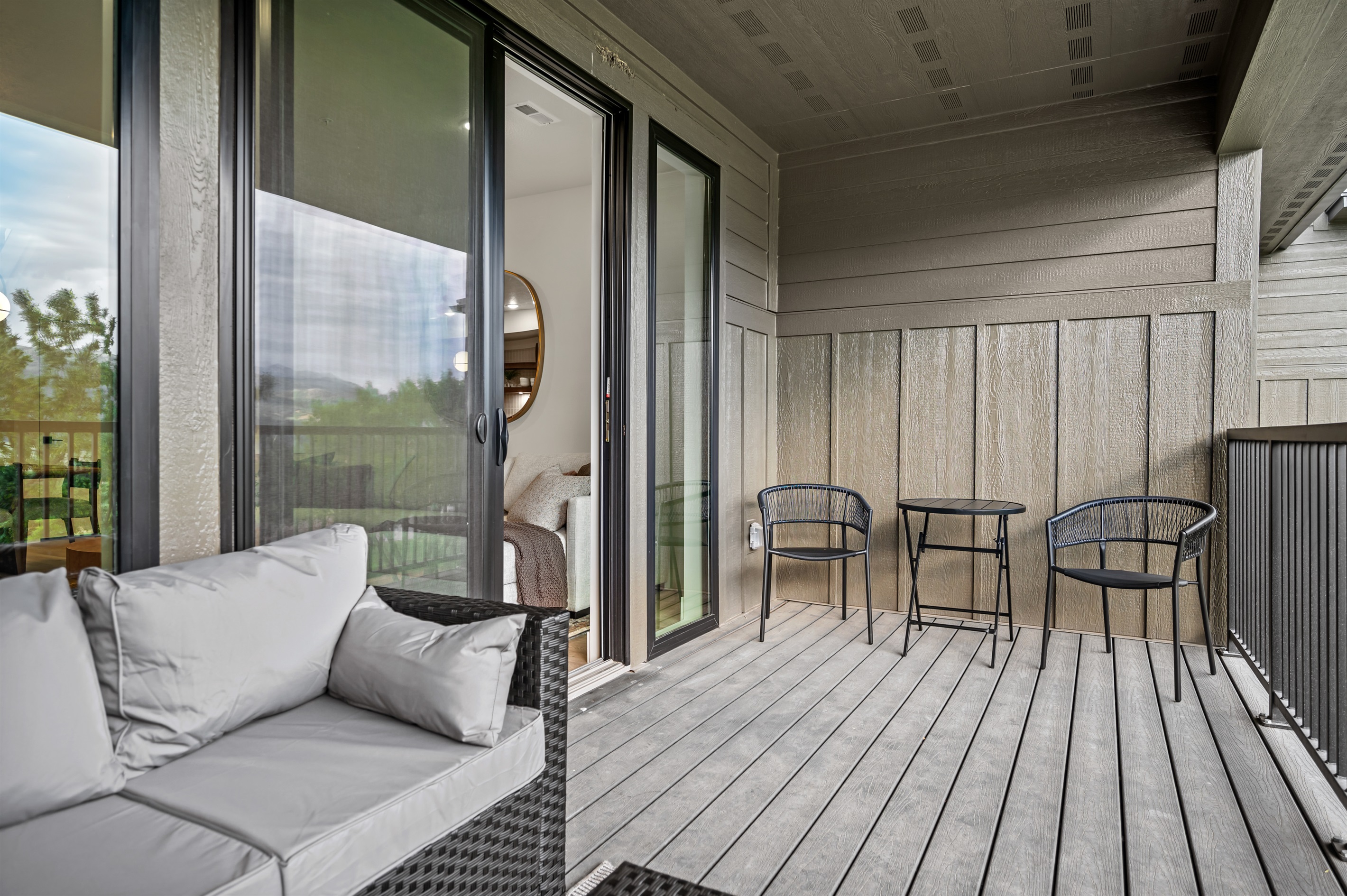 Sliding doors open to a furnished deck, creating the perfect space to relax and take in the fresh mountain air.